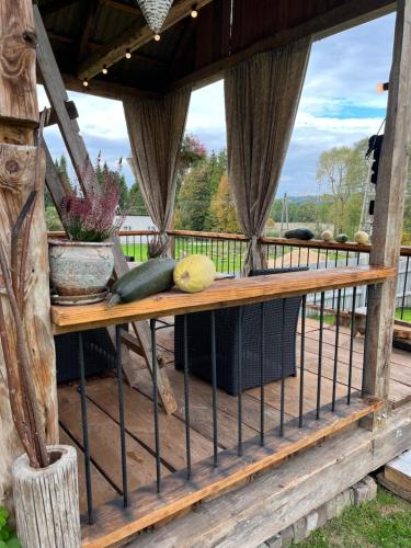 a wooden porch with a bench on a deck at Chata Borówkowe Wzgórze in AdamÃ³w