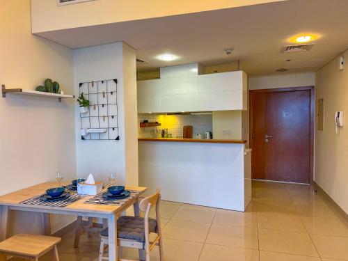 a kitchen and dining room with a table and chairs at Exquisite, luxe 1BD Apartment, Unparalleled Sea Views, Prime Dubai Marina Location & Full Kitchen by "La Buena Vida Holiday Homes in Dubai