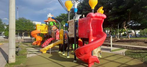 a row of colorful slides in a park at Peñazul La Aldea Condominio en Ricaurte Campestre - Apartamento con vista a piscinas in Ricaurte