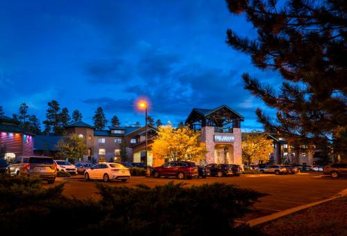 a parking lot with cars parked in front of a building at The Grand Hotel at the Grand Canyon in Tusayan