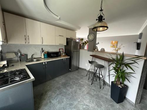 a kitchen with a stove and a counter top at UP in Stepantsminda