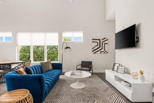 a living room with a blue couch and a table at Mason Lofts at West End in Nashville