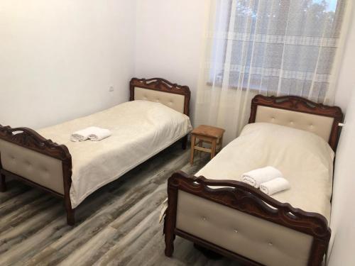 a bedroom with two beds and a window at Liga Hotel and Restaurant in Shinuhayr