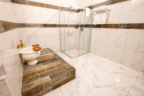 a bathroom with a shower and a toilet and a sink at Mesken Cave Suites in Nevsehir