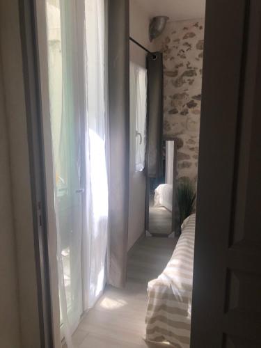 an open door to a room with a bed and a window at Vieil Antibes, ravissant 2p avec petite terrasse in Antibes