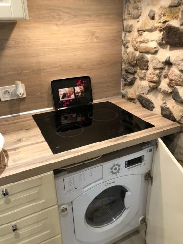 a kitchen with a counter with a washing machine at Vieil Antibes, ravissant 2p avec petite terrasse in Antibes