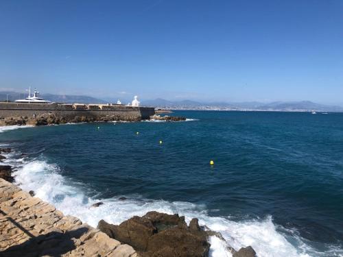 a large body of water with waves and rocks at Vieil Antibes, ravissant 2p avec petite terrasse in Antibes