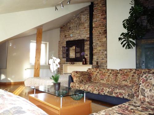 a living room with a couch and a table at Cheap And Chic in Rīga