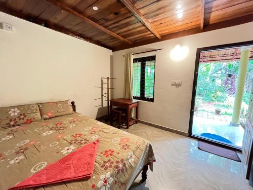 a bedroom with a bed and a large projection screen at Munroe Nest Homestay in Munroe Island
