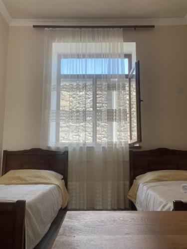 a bedroom with two beds and a window at Liga Hotel and Restaurant in Shinuhayr