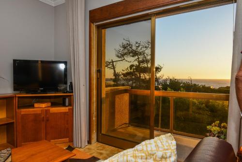 a living room with a large window with a view of the ocean at Casa da Amorosa by Lethes Legacy in Abelheira