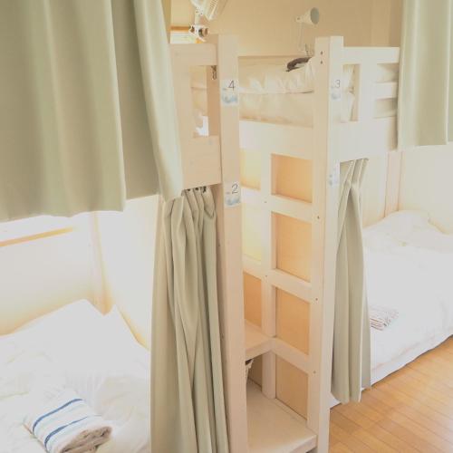 Ένα ή περισσότερα κρεβάτια σε δωμάτιο στο Tokushima GuestHouse【uchincu】