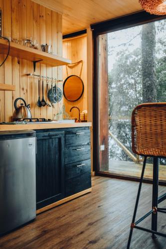 a kitchen with a sink and a counter top at OUTSCAPE l Refugios Puerto Fuy, Huilo Huilo in Puerto Fuy
