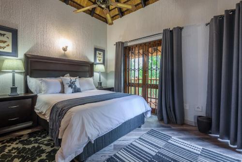 Postel nebo postele na pokoji v ubytování Kruger Park Lodge Unit No. 221