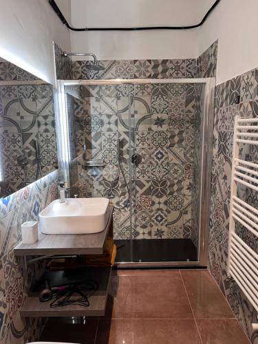 a bathroom with a sink and a shower at Minardi Apartments in Vercelli