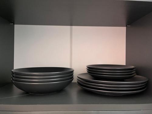 two stacks of plates sitting on a shelf at Minardi Apartments in Vercelli