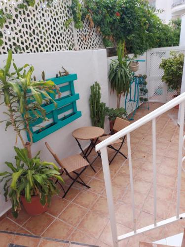 a balcony with plants and a blue bench at Loft Escobar in Nerja