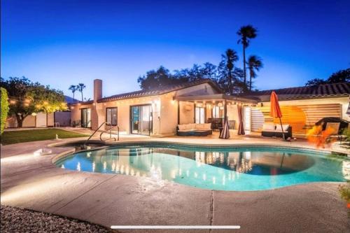 a swimming pool in front of a house at Fiesta Escuela in Palm Springs