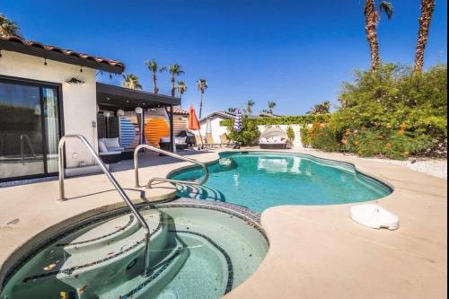 a swimming pool in front of a house at Fiesta Escuela in Palm Springs