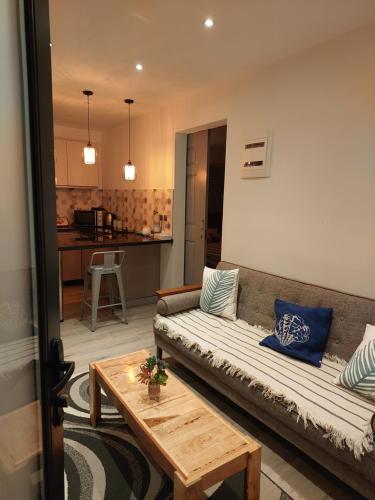 a living room with a couch and a table at AJ Studio Apartment in Moka