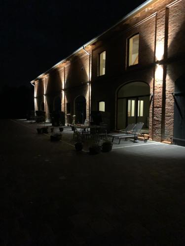 a building lit up at night with chairs in front at Ferienwohnung 2 am Herrenhaus Ahrensbök in Ahrensbök