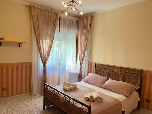 a bedroom with a bed with two towels on it at Sorrento's Carme family big appartament in Sorrento
