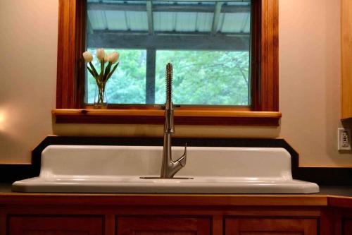 a sink with a faucet in front of a window at Hiking, MTB, four wheeling, fishing lakes, beaches, skiing, snowboarding, in Barton