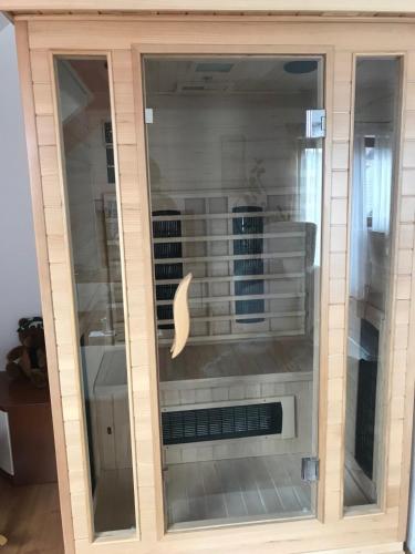 a large glass cabinet with a dishwasher in it at Apartman Bosco in Ravna Gora