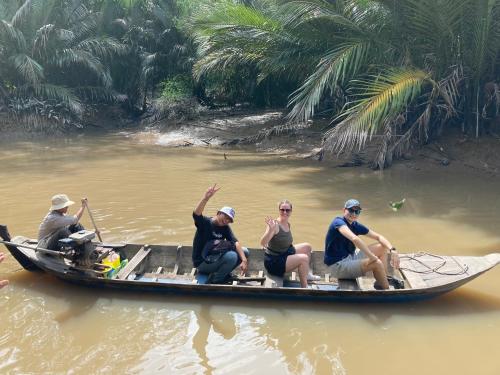 a group of people sitting on a boat in the water at BenTrestay in Giồng Tú Ðiền