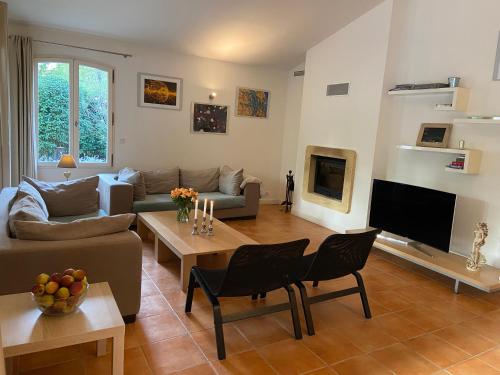 a living room with a couch and a table at Fayence Villa with private pool in Fayence