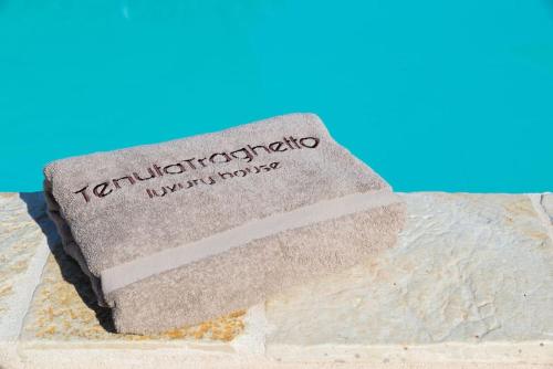 a label on a piece of sand on a beach at Tenuta Traghetto in Ostuni