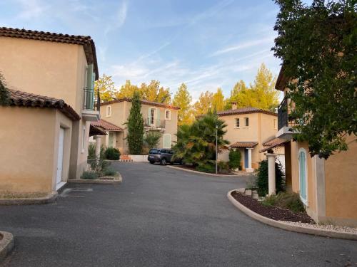 a street in a town with houses and a car at Fayence Villa with private pool in Fayence