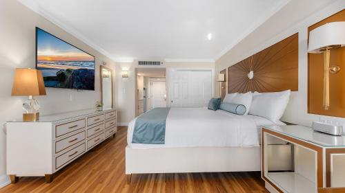 a large white bedroom with a large bed and a desk at La Mer Beachfront Resort in Cape May