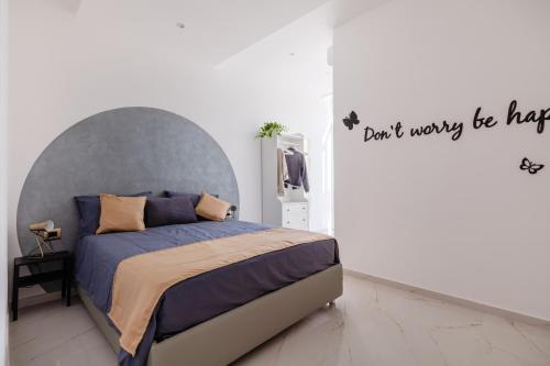 a bedroom with a bed with a gray headboard at La Casa di Armida Boutique homes con sauna in Naples