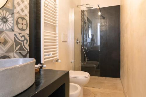 a bathroom with a sink and a toilet and a shower at Tenuta Traghetto in Ostuni