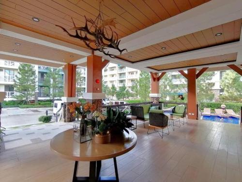 a patio with a table with flowers on it at KILA Homes at Pine Suites Tagaytay in Tagaytay