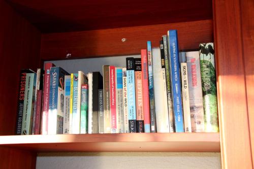 a row of books on a book shelf at Kruger Ranch in Magaliesburg