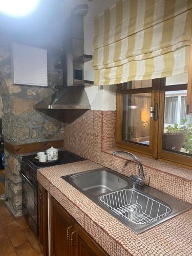 a kitchen with a sink and a stove at Urban River House in Florina