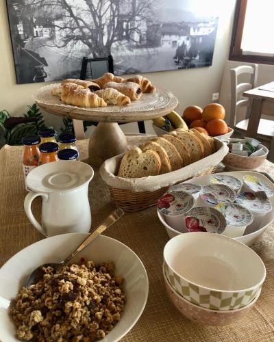 a table topped with different types of bread and pastries at Locanda B&B Da Nati in Arba