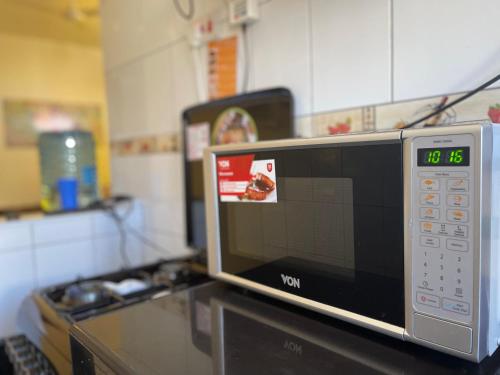a microwave oven sitting on top of a kitchen counter at Unique apartment in Mombasa