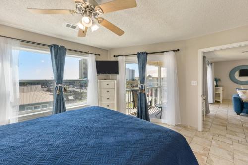 a bedroom with a blue bed and a large window at 200 yds to private gated beach access- 3BR-2BA- quiet location in the heart of Destin! in Destin
