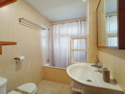 a bathroom with a sink and a toilet and a window at ESTUDIO LUNA in Sierra Nevada