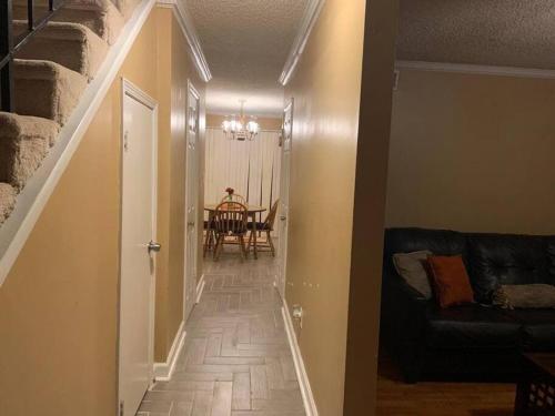 a hallway with a staircase leading to a dining room at #2BR Cozy Villa - Mins to Historic STM Amusement Park! in Stone Mountain
