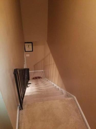 a staircase in a room with a stair case at #2BR Cozy Villa - Mins to Historic STM Amusement Park! in Stone Mountain