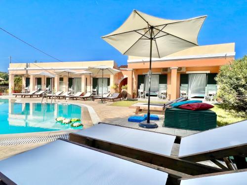 a villa with a swimming pool and an umbrella at Villa Bougarini with private pool by DadoVillas in Velonádes