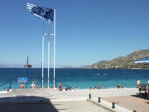 a group of people on a beach near the water at Hotel Excelsior in Loutraki