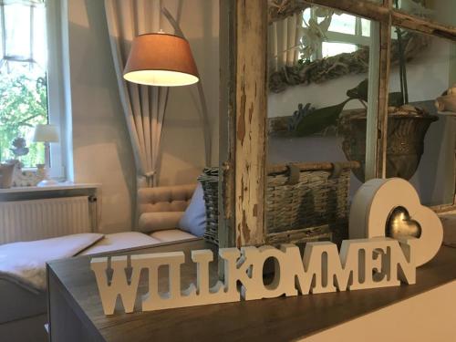 a living room with a sign that reads wild woman at Apartments Villa Seeblick Travemünde in Travemünde