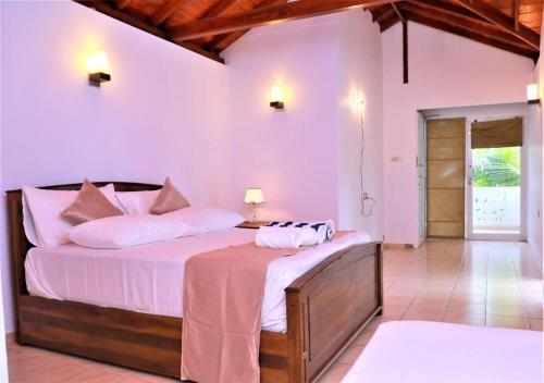 a bedroom with a bed in a room at Shenora Beach Resort in Hikkaduwa
