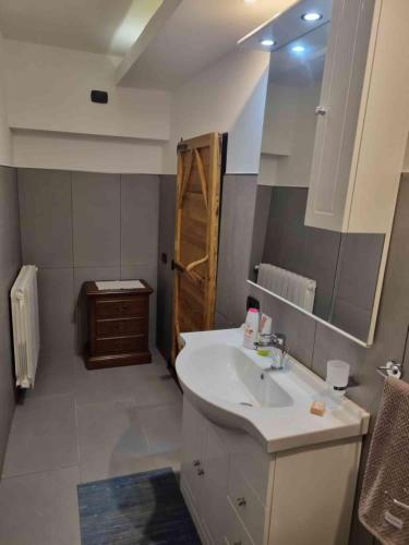 a bathroom with a sink and a mirror at B&B la Curt del Böff in Lasnigo