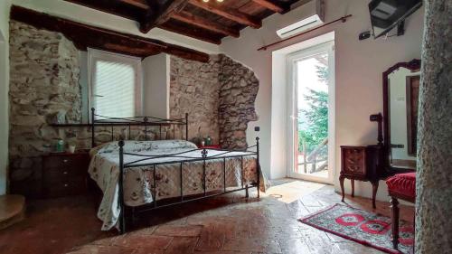 a bedroom with a bed and a large window at B&B la Curt del Böff in Lasnigo